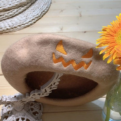 Halloween party hat made of wool with a jack-o'-lantern face design in beige for spooky dress-up atmosphere