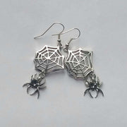 Silver spider web Halloween earrings with dangling spiders, gothic metal jewelry for unisex.