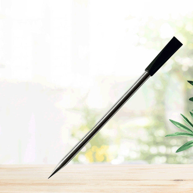 Mini BBQ Bluetooth thermometer probe with black handle on wooden surface and blurred background