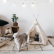 Canvas pet tent bed with pom-pom trim, pine wood frame, and cushion, perfect for cats and small dogs.