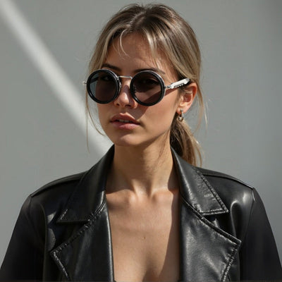 2025 New ND dimmable sunglasses with round TAC lenses and aluminum magnesium full rim frame worn by woman in black leather jacket